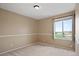Neutral bedroom featuring neutral carpet, chair rail, and large window with view at 708 S Carlton St, Castle Rock, CO 80104