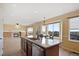 Kitchen island with granite countertops, and stainless steel dishwasher, connecting the kitchen to the cozy living area at 708 S Carlton St, Castle Rock, CO 80104