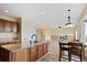 Open-concept kitchen with granite countertops, island, and views of the living room with a fireplace, ideal for gatherings at 708 S Carlton St, Castle Rock, CO 80104
