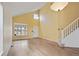 Bright living room featuring vaulted ceilings, hardwood floors and adjacent stairway at 708 S Carlton St, Castle Rock, CO 80104