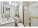 Bright bathroom with gold accents and glass shower door at 9117 Buck Hill Dr, Highlands Ranch, CO 80126