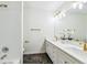 Bathroom featuring dual sinks, updated lighting, and white cabinets at 9117 Buck Hill Dr, Highlands Ranch, CO 80126