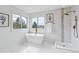 Bright bathroom featuring a standalone tub, a glass shower, and decorative tile accents at 9117 Buck Hill Dr, Highlands Ranch, CO 80126