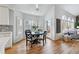 Charming breakfast nook with a round table, hardwood floors, and natural light streaming through the shuttered windows at 9117 Buck Hill Dr, Highlands Ranch, CO 80126