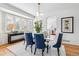 Elegant dining room with a glass-top table, stylish chairs, and modern light fixture at 9117 Buck Hill Dr, Highlands Ranch, CO 80126