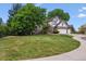 Beautiful two-story home boasts a manicured lawn, mature trees, and a three-car garage with plenty of curb appeal at 9117 Buck Hill Dr, Highlands Ranch, CO 80126