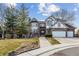 Beautiful two-story home featuring brick and Tudor accents, a three-car garage, and professional landscaping at 9117 Buck Hill Dr, Highlands Ranch, CO 80126