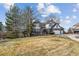 Desirable two-story home featuring brick and Tudor elements, complemented by mature trees and landscaping at 9117 Buck Hill Dr, Highlands Ranch, CO 80126