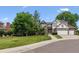 Charming two-story home with brick and neutral trim and a three-car garage at 9117 Buck Hill Dr, Highlands Ranch, CO 80126
