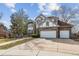 Attractive two-story home showcasing brick and Tudor detailing, with a spacious three-car garage at 9117 Buck Hill Dr, Highlands Ranch, CO 80126