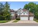 Charming two-story home with brick and neutral trim and a three-car garage at 9117 Buck Hill Dr, Highlands Ranch, CO 80126