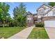 Well-manicured front yard leads to this charming two-story home with brick and neutral trim at 9117 Buck Hill Dr, Highlands Ranch, CO 80126