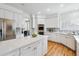 Bright and airy kitchen with white cabinets, stainless steel appliances, and center island offers a great cooking space at 9117 Buck Hill Dr, Highlands Ranch, CO 80126