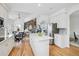 Open-concept kitchen flows into the breakfast nook and living room, featuring white cabinetry and stainless appliances at 9117 Buck Hill Dr, Highlands Ranch, CO 80126