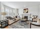 Inviting living room with fireplace, large windows, and stylish furnishings at 9117 Buck Hill Dr, Highlands Ranch, CO 80126