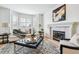 Bright living room featuring a fireplace, bay windows, and elegant decor at 9117 Buck Hill Dr, Highlands Ranch, CO 80126