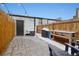 Private backyard with a stone patio, wooden fence and string lights, perfect for outdoor entertaining at 3005 California St, Denver, CO 80205