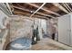 Unfinished basement with exposed brick and exposed utilities at 3005 California St, Denver, CO 80205