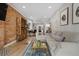 Open living area with exposed brick, wood floors, and a seamless transition to the kitchen at 3005 California St, Denver, CO 80205