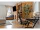 Comfortable living room area with brick wall accent, shelving, and a large window seat at 3005 California St, Denver, CO 80205