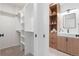 Contemporary bathroom featuring a walk-in closet, a wooden vanity, and bright white cabinets, blending style and functionality at 2206 Alpine Dr, Boulder, CO 80304
