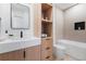 Bright bathroom with custom vanity, shelving, and a shower tub at 2206 Alpine Dr, Boulder, CO 80304