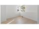 Bright and airy bedroom with hardwood floors, white walls, and a large window offering natural light at 2206 Alpine Dr, Boulder, CO 80304