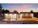 Charming modern home featuring sleek lines, a wood garage door, and a well-manicured front yard at sunset at 2206 Alpine Dr, Boulder, CO 80304