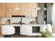 Modern kitchen with sleek wood cabinets, white countertops, an island with seating, and stylish pendant lighting at 2206 Alpine Dr, Boulder, CO 80304