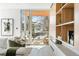 Bright living room with built-in shelves, comfortable seating, and sliding glass doors leading to a balcony at 2206 Alpine Dr, Boulder, CO 80304