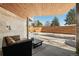 Outdoor patio featuring a covered seating area with a view of the landscaped backyard with a privacy fence at 2206 Alpine Dr, Boulder, CO 80304