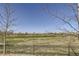 Scenic back view of a home overlooking a golf course with a black metal fence at 5131 Netherland St, Denver, CO 80249