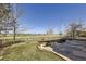Charming backyard with a stone patio and view of the green golf course at 5131 Netherland St, Denver, CO 80249