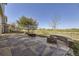 Beautiful stone patio with fire pit and view of the golf course at 5131 Netherland St, Denver, CO 80249