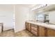 Bright bathroom with double vanity, ample lighting and tiled flooring at 5131 Netherland St, Denver, CO 80249
