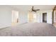 Open bedroom area featuring an overhead ceiling fan and a hallway to the bathroom at 5131 Netherland St, Denver, CO 80249