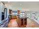Bright kitchen boasts an island, wooden cabinets, hardwood floors, and stainless steel appliances at 5131 Netherland St, Denver, CO 80249