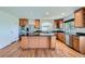 Bright, open kitchen boasts stainless steel appliances, a center island, and ample counter space at 5131 Netherland St, Denver, CO 80249