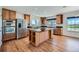 Spacious kitchen boasts stainless steel appliances, a center island, and plenty of cabinet space at 5131 Netherland St, Denver, CO 80249