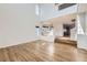 Bright living room with hardwood floors, high ceilings, and a seamless connection to the dining area at 5131 Netherland St, Denver, CO 80249