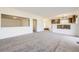Open concept living room leading to the kitchen, with neutral paint and carpet at 5131 Netherland St, Denver, CO 80249