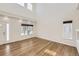 Bright living room featuring hardwood floors, large windows, and ample natural light at 5131 Netherland St, Denver, CO 80249