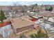 Backyard view of a brick ranch home with a wooden deck at 4611 S Queen St, Littleton, CO 80127