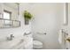 Small bathroom with white vanity and toilet at 4611 S Queen St, Littleton, CO 80127