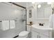 Bathroom with white vanity, shower, and framed mirror at 4611 S Queen St, Littleton, CO 80127