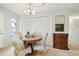 Bright dining room with wood table and chairs, built-in storage, and art at 4611 S Queen St, Littleton, CO 80127