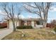 Brick ranch home with attached garage and front yard at 4611 S Queen St, Littleton, CO 80127