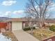 Brick ranch home with attached garage and a driveway at 4611 S Queen St, Littleton, CO 80127