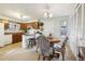 Kitchen features wood cabinets, a breakfast bar, and a dining area at 4611 S Queen St, Littleton, CO 80127