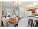 Kitchen with wood cabinets, island, and white appliances at 4611 S Queen St, Littleton, CO 80127